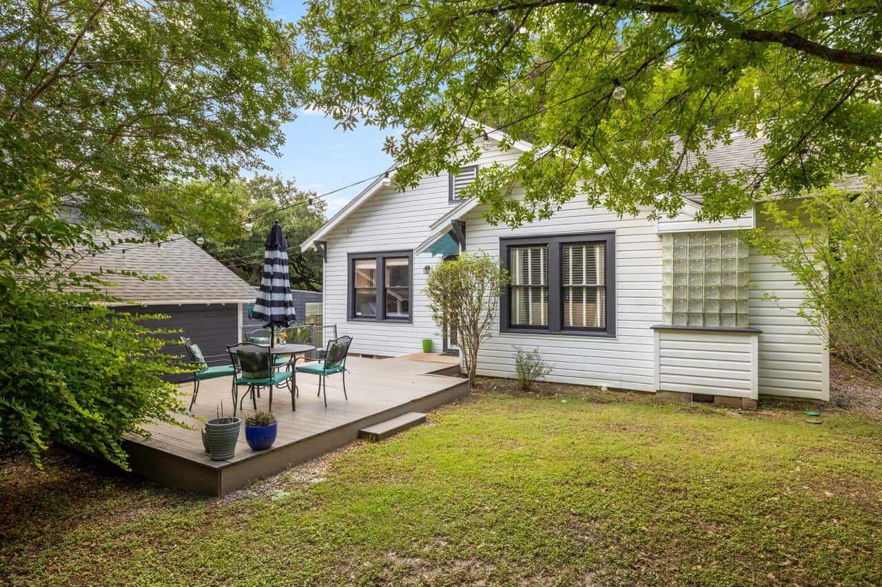 The back deck at SoCo Cottage with patio seating and umbrella