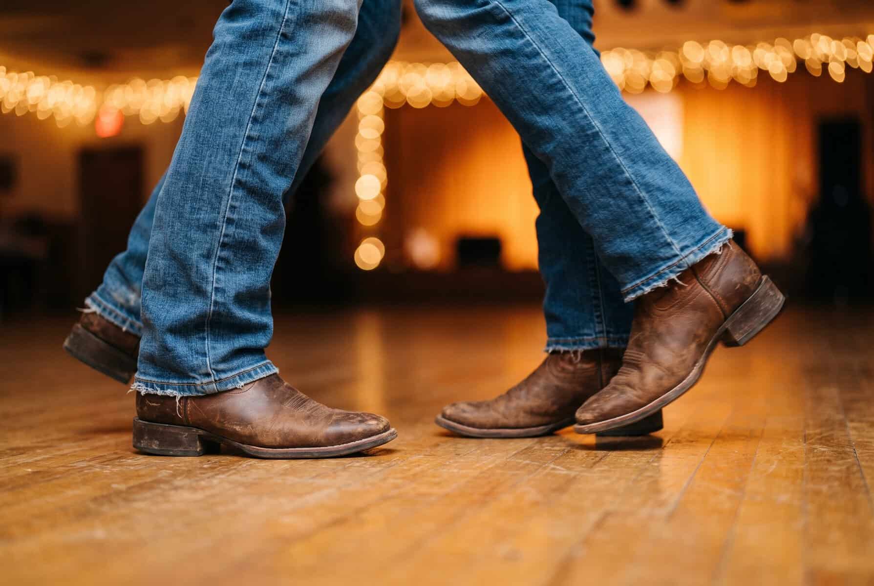 Free Things to Do in Austin (That Locals Actually Do) Two pairs of cowboy boots two-stepping on a wooden dance floor under string lights